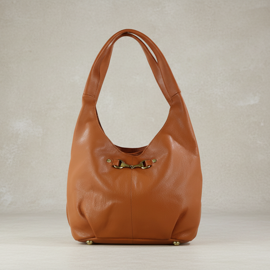 Brown leather handbag on a neutral background