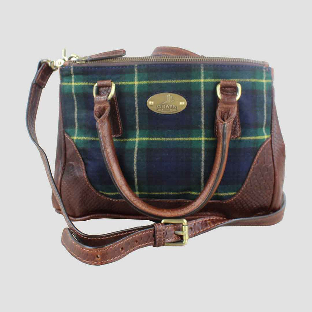 Plaid bag with brown leather accents on a light gray background