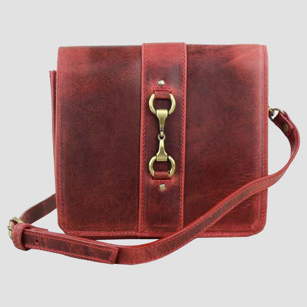 Red leather handbag with gold hardware on a light gray background