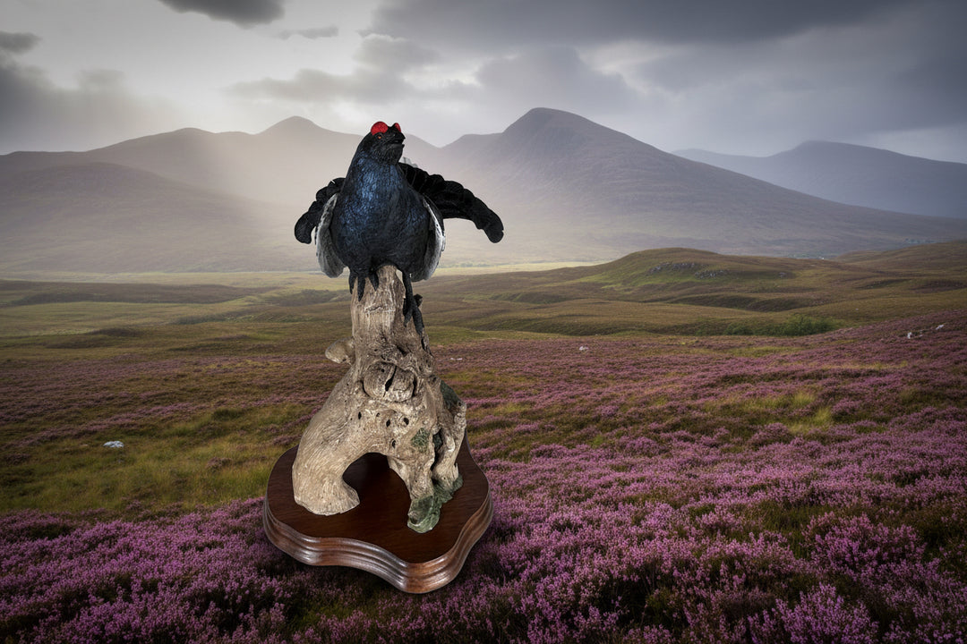 Decorative sculpture of a bird on a branch with a wooden base against a light gray background