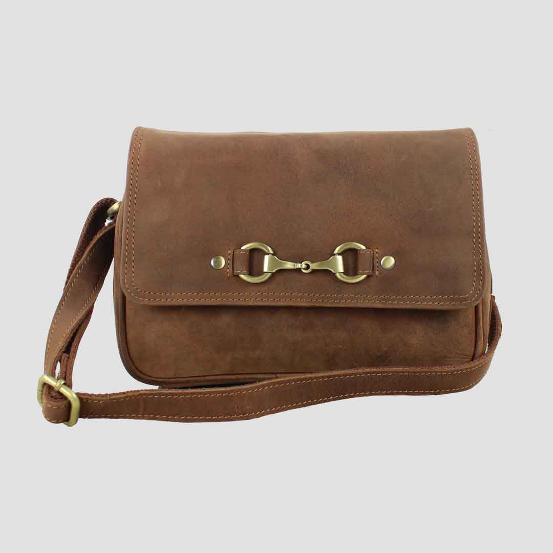 A brown leather handbag with a metal bit fastener closure and an adjustable shoulder strap.